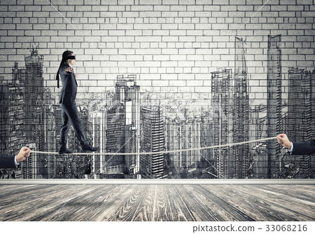 Business concept of risk support and assistance with man balancing on rope Business concept of risk support and assistance with man balancing on rope 33068216