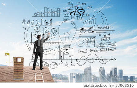 Rear view of businessman on house roof drawing his new business strategy. Mixed media 33068510