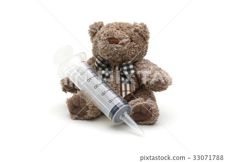 Isolated teddy bear toy holding syringe on white Isolated teddy bear toy holding syringe on white 33071788