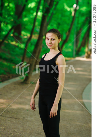 Girl doing stretching outdoors Girl doing stretching outdoors 33073089