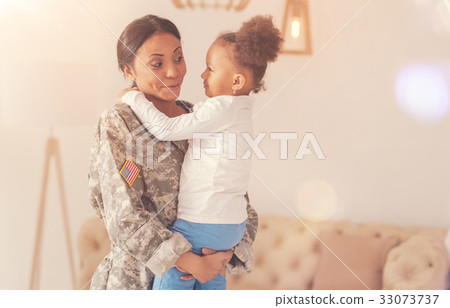 Joyful mother in camouflage holding her little 33073737