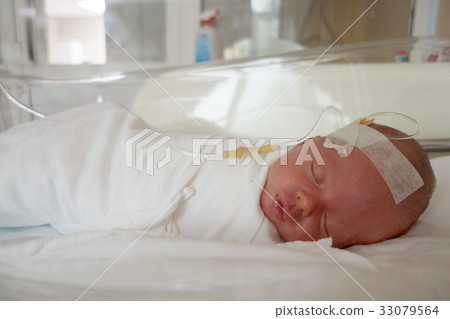 Newborn baby sleeping on a drip in a hospital Newborn baby sleeping on a drip in a hospital 33079564
