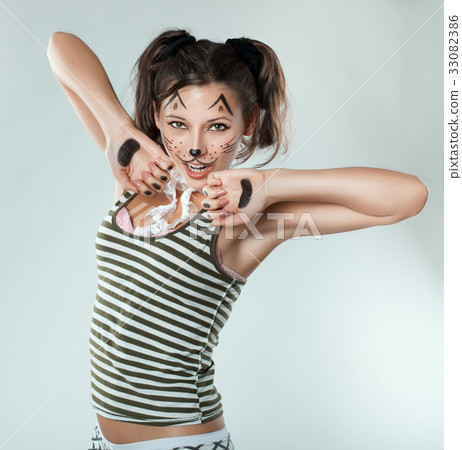 Mischievous girl painted like a cat. Mischievous girl painted like a cat. 33082386