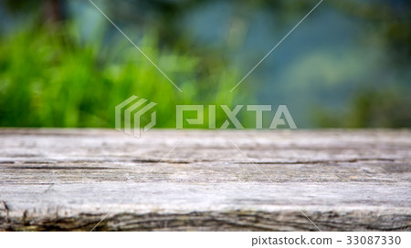 Empty wooden table with garden in the background. Empty wooden table with garden in the background. 33087330