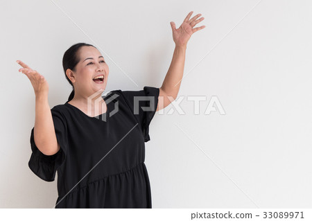 exited happy smiling middle age woman looking up 33089971