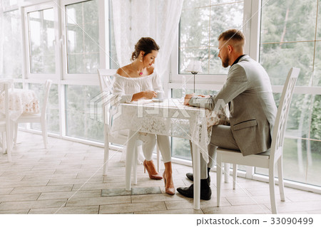 Flirting in a cafe. Beautiful loving couple Flirting in a cafe. Beautiful loving couple 33090499