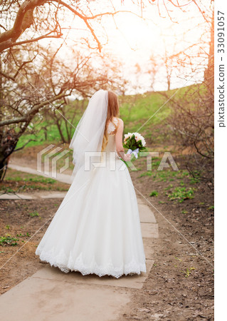 Bride in the garden. Stylish wedding bride with 33091057