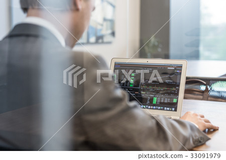 Young businessman working with laptop, man's hands 33091979