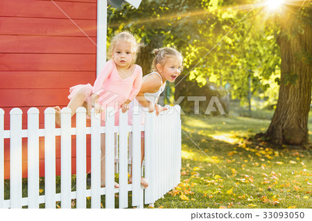 The two little girls at playground against park or 33093050