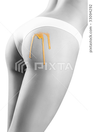 Honey flows down on woman buttocks. Honey flows down on woman buttocks. 33094292
