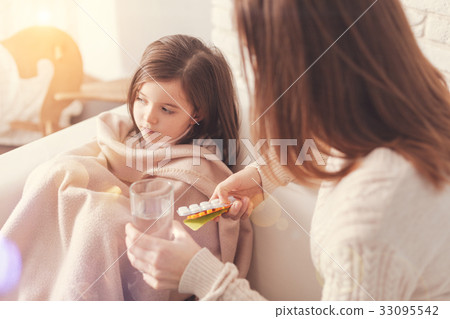 Upset girl pressing lips while looking aside Upset girl pressing lips while looking aside 33095542