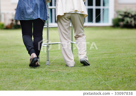 Elderly woman walking in backyard with daughter Elderly woman walking in backyard with daughter 33097838