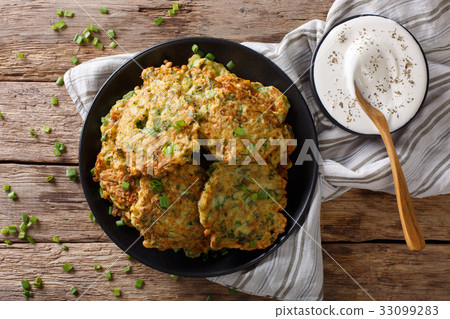 Homemade zucchini fritters with greens Homemade zucchini fritters with greens 33099283