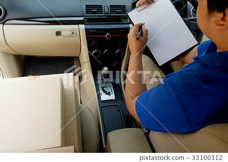 Delivery driver driving with parcels on seat. Delivery driver driving with parcels on seat. 33100312