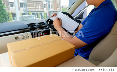 Delivery driver driving with parcels on seat. 33100313
