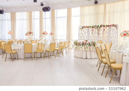 room with covered tables for event dinner room with covered tables for event dinner 33107962