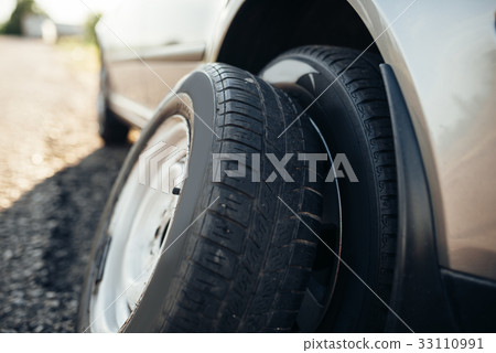 Broken car concept, spare wheel replacement 33110991