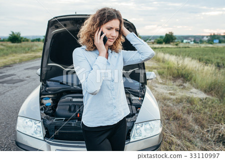 Woman calls to emergency service, broken car 33110997