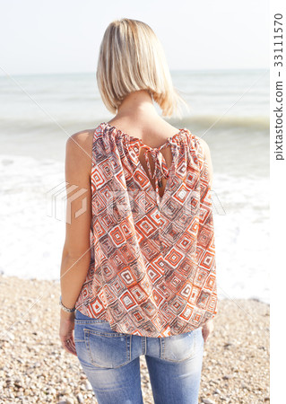 Young woman on beach Young woman on beach 33111570