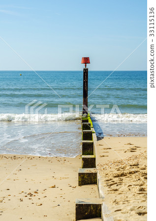 Dock pilings on a sandy beach Dock pilings on a sandy beach 33115136