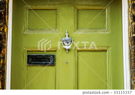 Door with brass knocker in the shape of a hand Door with brass knocker in the shape of a hand 33115157