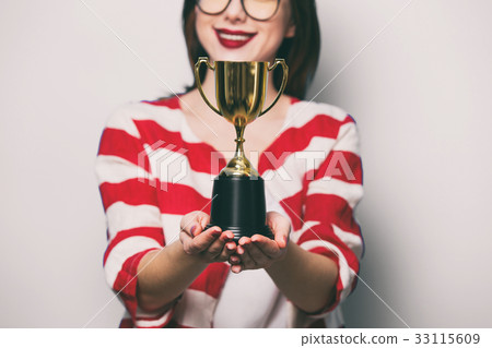 young smiling woman with cup trophy 33115609