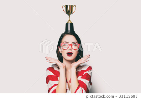 young surprised woman with cup trophy 33115693