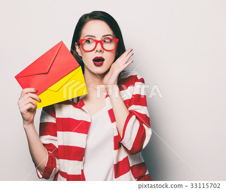 surprised woman with two envelopes 33115702