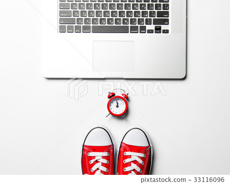 clock, gumshoes and laptop 33116096