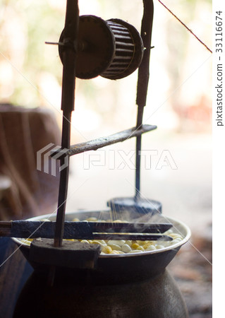 Boiling silkworm cocoon in the pot for process 33116674