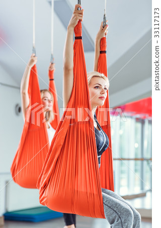 Fly yoga. two women practices anti-gravity yoga Fly yoga. two women practices anti-gravity yoga 33117173
