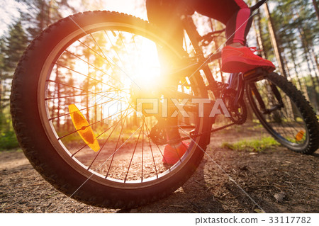 Woman riding a mountain bicycleat the forest Woman riding a mountain bicycleat the forest 33117782