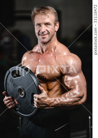 Handsome fit caucasian muscular man flexing his muscles in gym 33118472