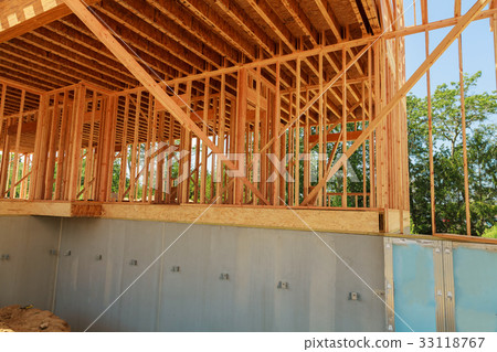 Wood framing on new house under construction Wood framing on new house under construction 33118767