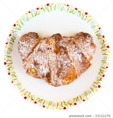 top view of croissant filled by cream on plate 33122270
