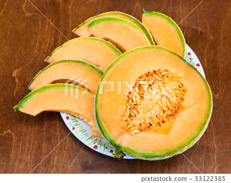 slices of ripe sicilian cantaloupe melon on table 33122385