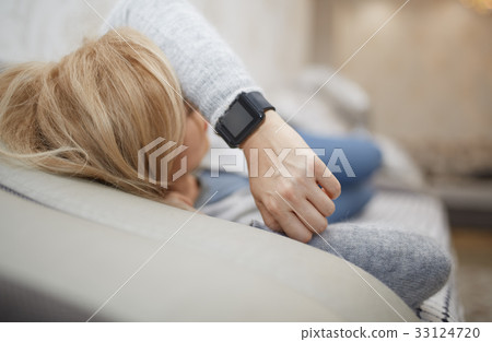Woman sleeping with smartwatch 33124720