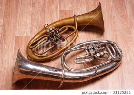 two old rusty alto saxhorn on wooden background 33125251