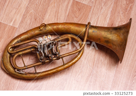 old rusty alto saxhorn on wooden background old rusty alto saxhorn on wooden background 33125273