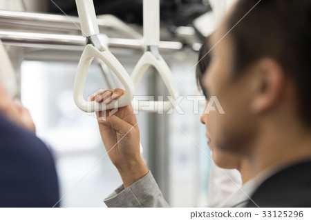 Women's hand holding a strap in the commuter train Shooting cooperation "Keio Electric Railway Co., Ltd." Women's hand holding a strap in the commuter train Shooting cooperation "Keio Electric Railway Co., Ltd." 33125296