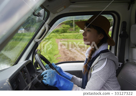 Woman driving light truck with rice planting farming work 33127322
