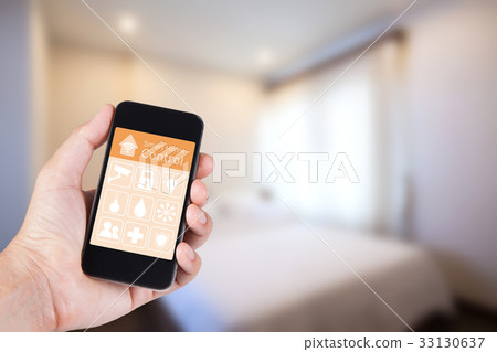Hand using smartphone to smart home app on mobile Hand using smartphone to smart home app on mobile 33130637