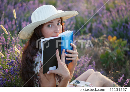Romantic woman with book on lavender field Romantic woman with book on lavender field 33131267