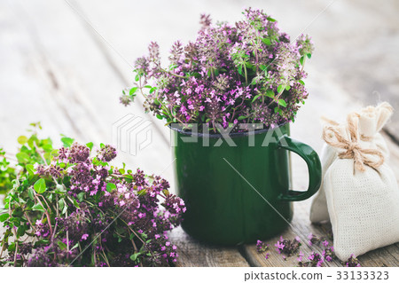 Enameled mug of thyme healing herbs and sachet.  33133323