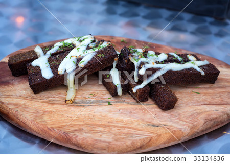 Slices of rye croutons on a wooden board 33134836