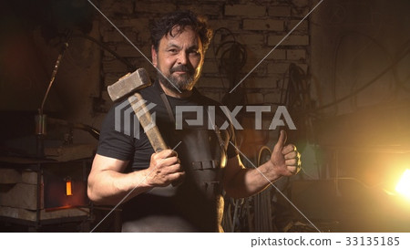 Cool blacksmith portrait with beard in workshop 33135185
