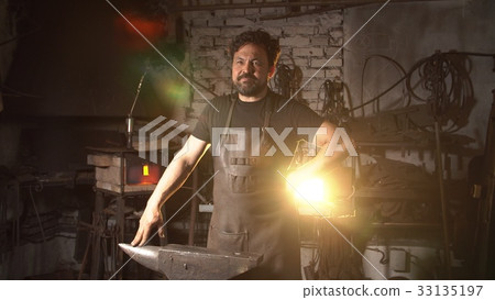 Portrait of a man of a blacksmith in the working 33135197