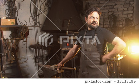 Cool blacksmith portrait with beard in workshop 33135199