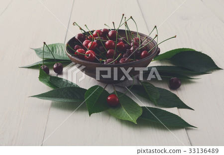 Fresh cherries bowl on white wood Fresh cherries bowl on white wood 33136489