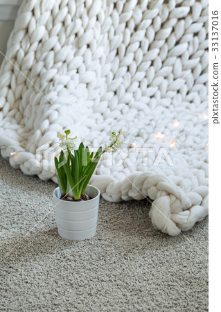 White scandinavian interior with knit plaid. White scandinavian interior with knit plaid. 33137016